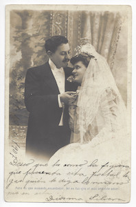 A bride and a groom looking at each other; sepia; handwritten and printed text. 