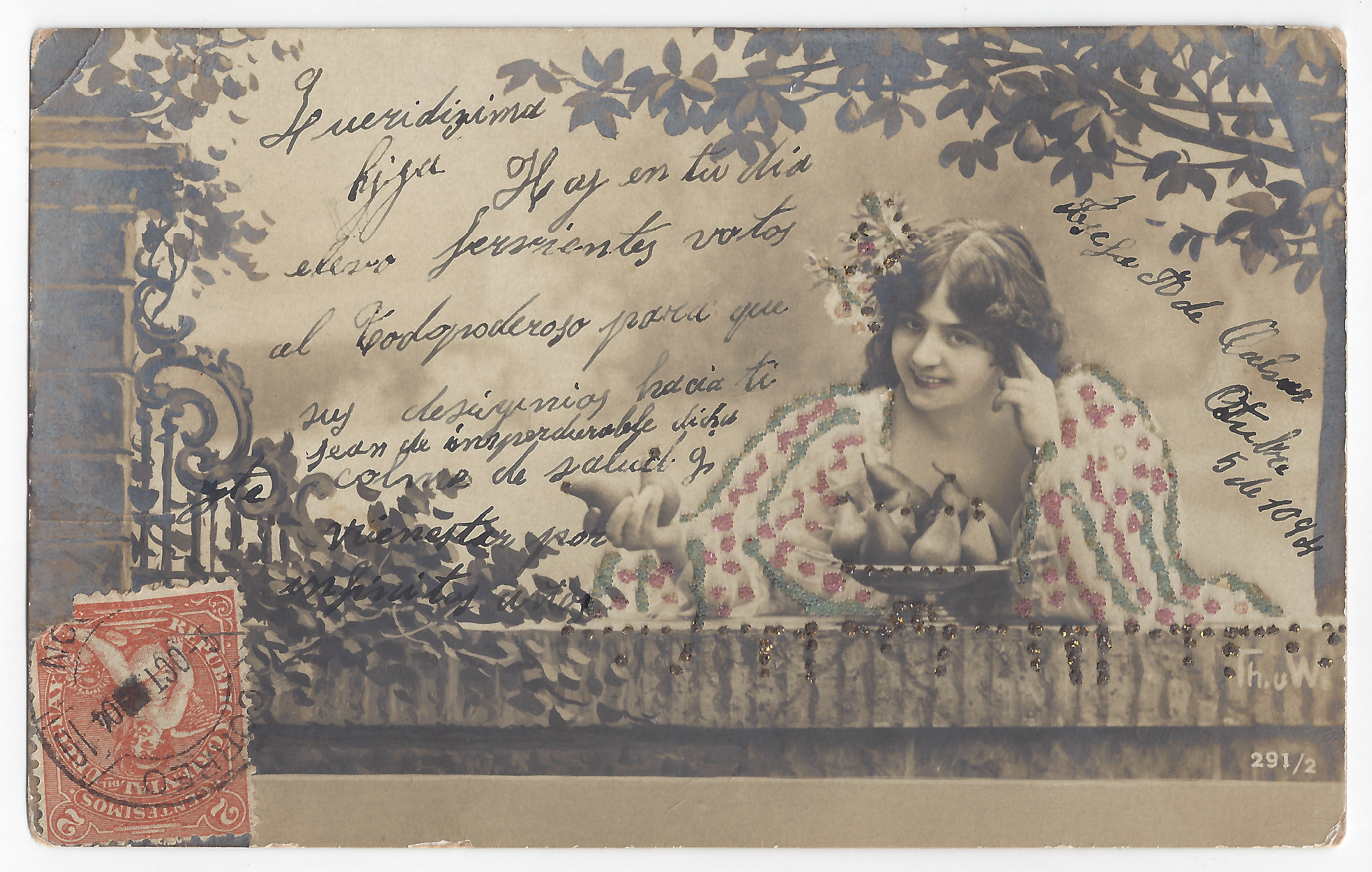 A woman with flowers in her hair and a bowl of fruit; sepia and colored glitter; handwritten text; one stamp.